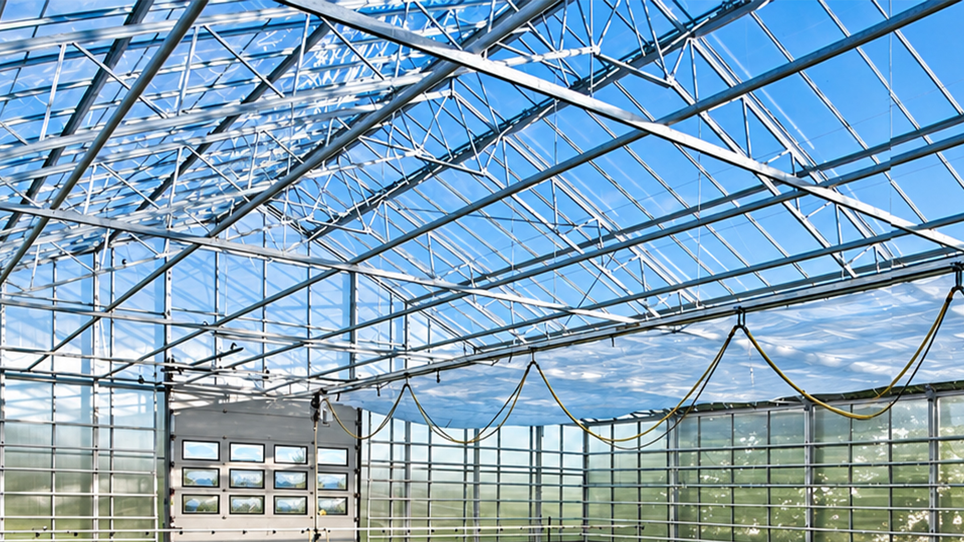 Commercial greenhouse roof structure with beams and suspension points for LED toplight installation